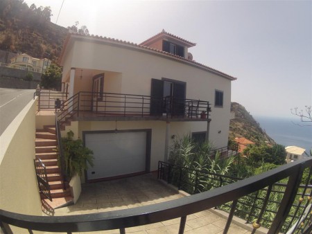 Wide angle view of the house and driveway to the garage